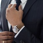 man wearing watch with black suit