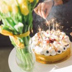 white and brown cake with candles on top