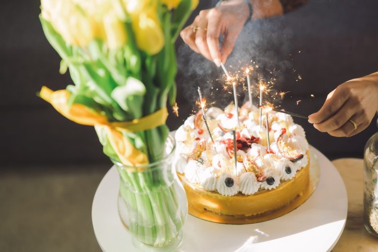 white and brown cake with candles on top