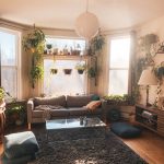 a living room filled with furniture and lots of plants