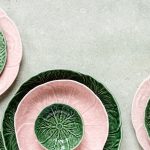 a group of green and pink plates sitting on top of a table