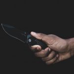 person holding black pocket knife