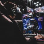 person sitting on gaming chair while playing video game