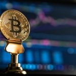 selective focus photo of Bitcoin near monitor