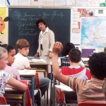 woman standing in front of children