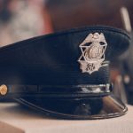 a police hat sitting on top of a box