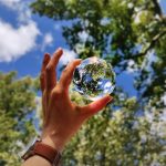 unknown person holding clear glass ball