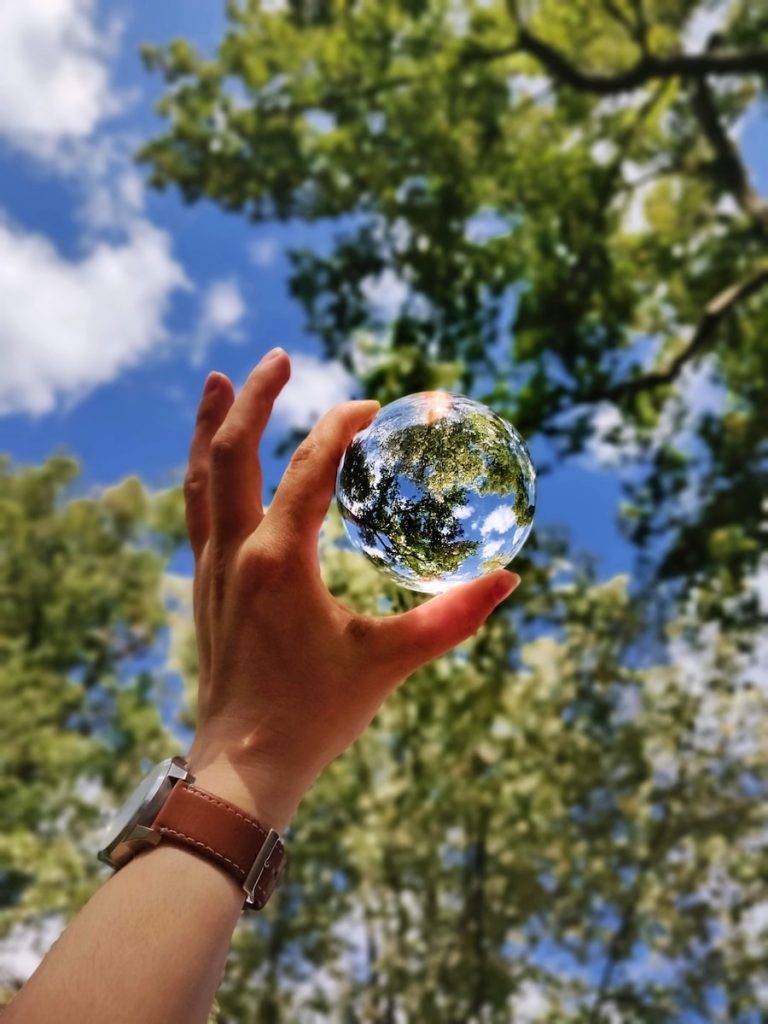 unknown person holding clear glass ball