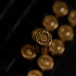 gold round coins on black surface