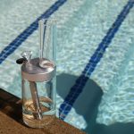 clear glass bottle on brown wooden table