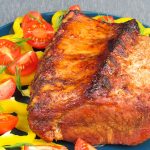 a blue plate topped with meat and vegetables