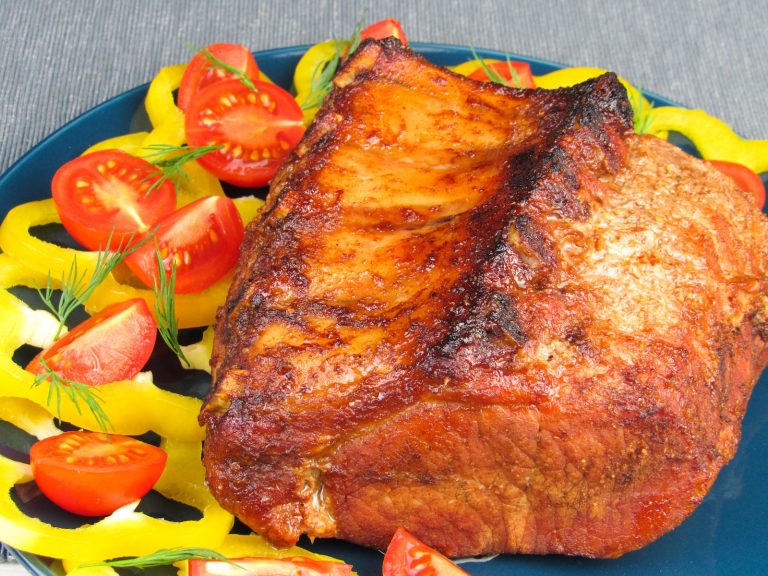 a blue plate topped with meat and vegetables