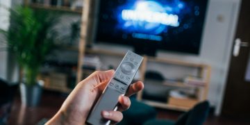 person holding gray remote control