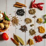 a variety of spices on a white table