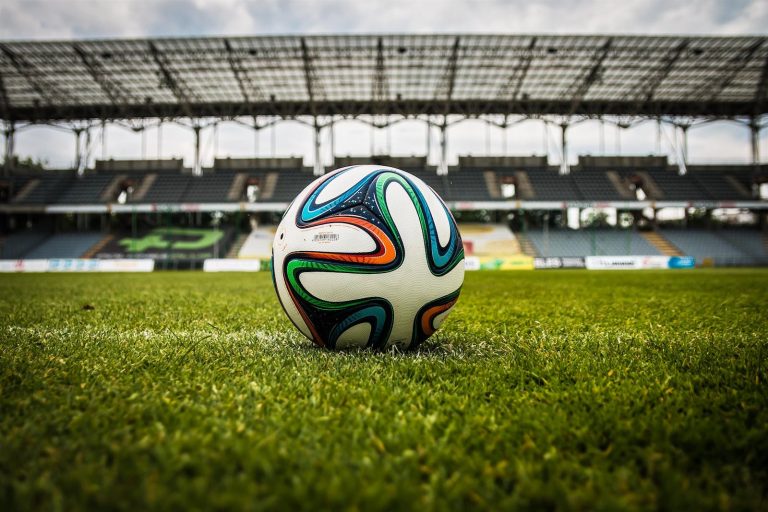 Multicolored Soccer Ball on Green Field