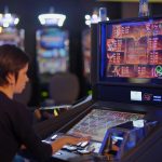 woman in black long sleeve shirt playing arcade game