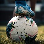 white and blue soccer ball on green grass field