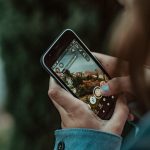 person holding black iphone 4