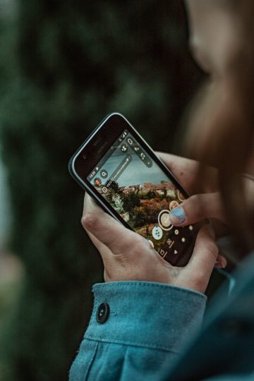 person holding black iphone 4