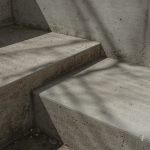 a concrete bench sitting next to a cement wall