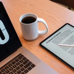 a tablet and a cup of coffee on a table