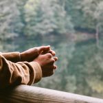 tilt-shift photography of person in brown jacket