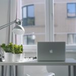 Silver Macbook Air and Goose Neck Lamp