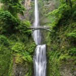 gray concrete bridge and waterfalls during daytime