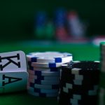 white and black dice on green table