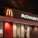 a mcdonald's restaurant is lit up at night