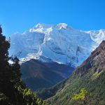 a view of a snow covered mountain from a distance