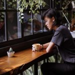 woman sitting on brown wooden chair