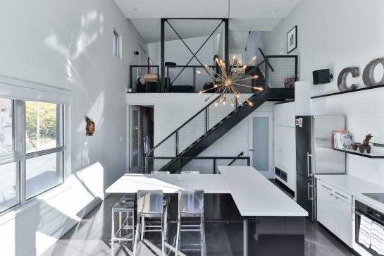 a kitchen with a staircase