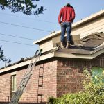 a man standing on the roof of a house