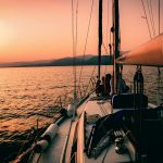 white and black sailboat during sunset