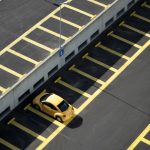 yellow coupe on parking lot at daytime