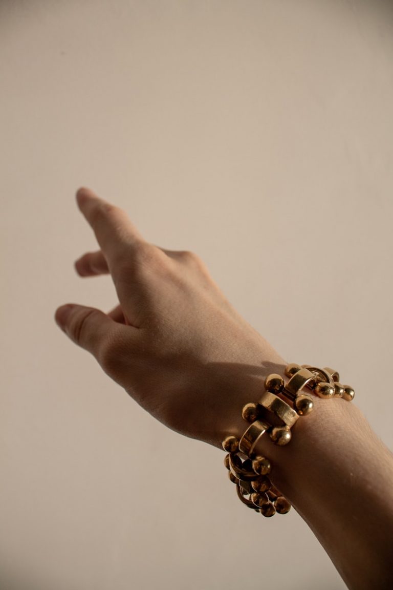 person wearing silver beaded bracelet