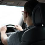 man driving car during daytime