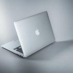 silver macbook on white table