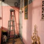 a ladder leaning up against a pink wall