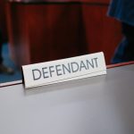 a desk with a sign on it that says defend