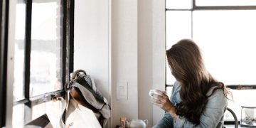 man holding white ceramic teacup