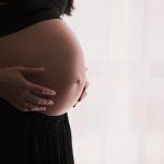 woman holding stomach