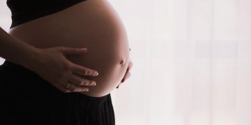 woman holding stomach