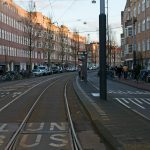 a street with cars and people