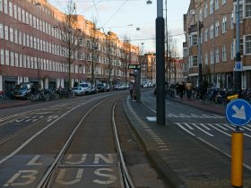 a street with cars and people