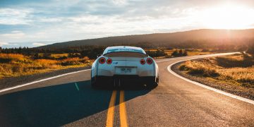 silver sports coupe on asphalt road