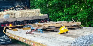 yellow and black heavy equipment on brown wooden pallet