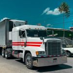 a large semi truck driving down a street