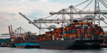 cargo ships docked at the pier during day